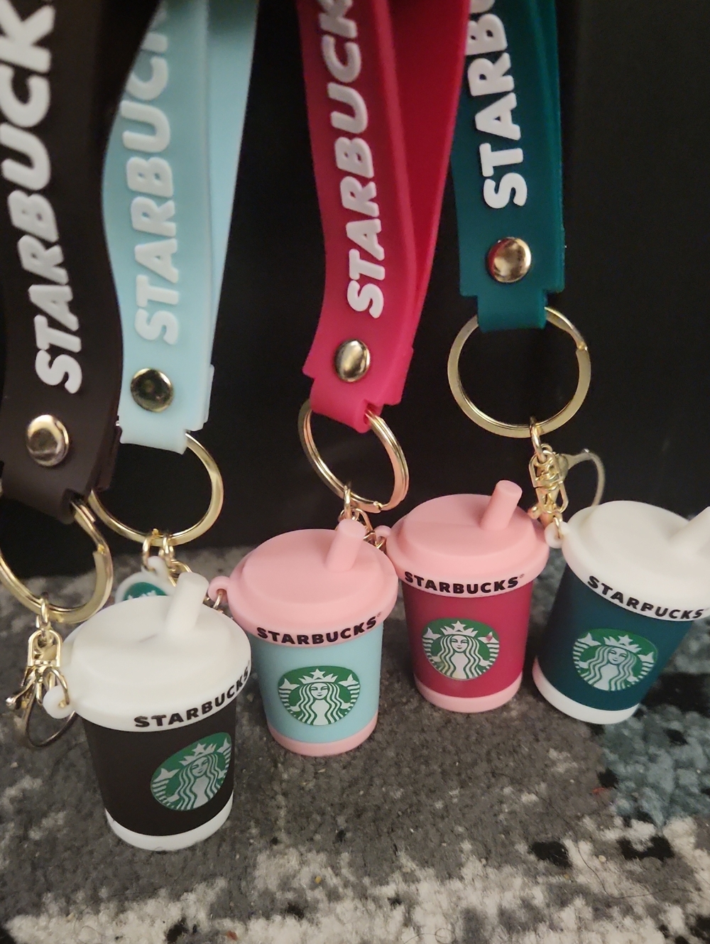 Set Of Four Starbucks Silicone Cup Keychains in Black, Light Blue, Pink, Teal